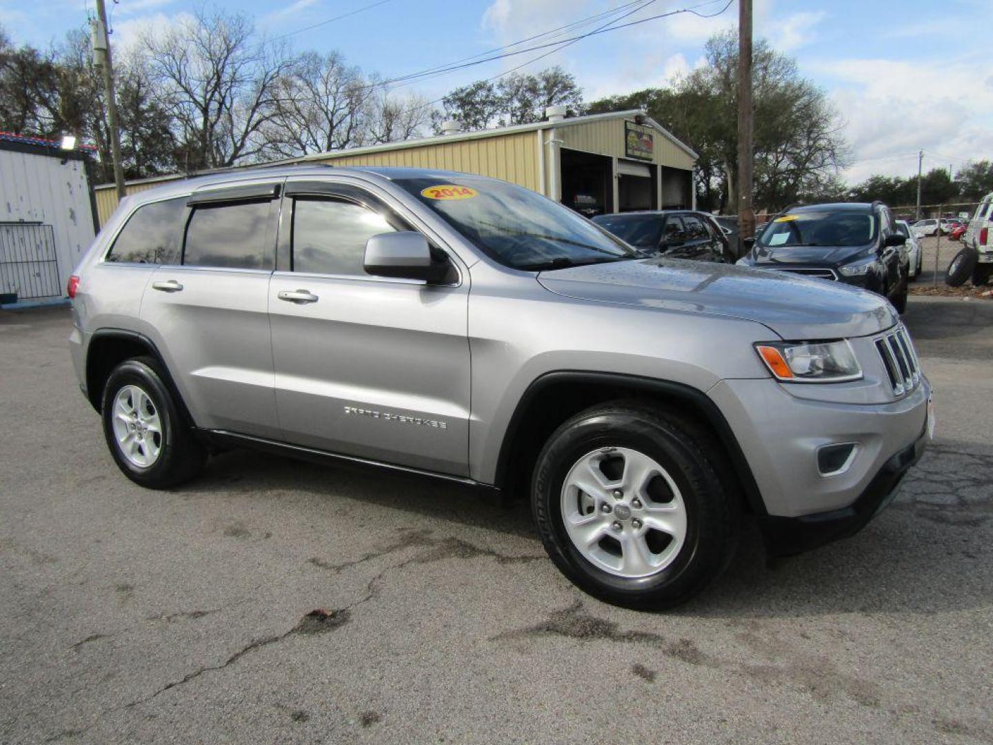 2014 SILVER JEEP GRAND CHEROKEE LAREDO (1C4RJEAG7EC) with an 3.6L engine, Automatic transmission, located at 830 E. Canino Rd., Houston, TX, 77037, (281) 405-0440, 38.358219, -81.729942 - Photo#1