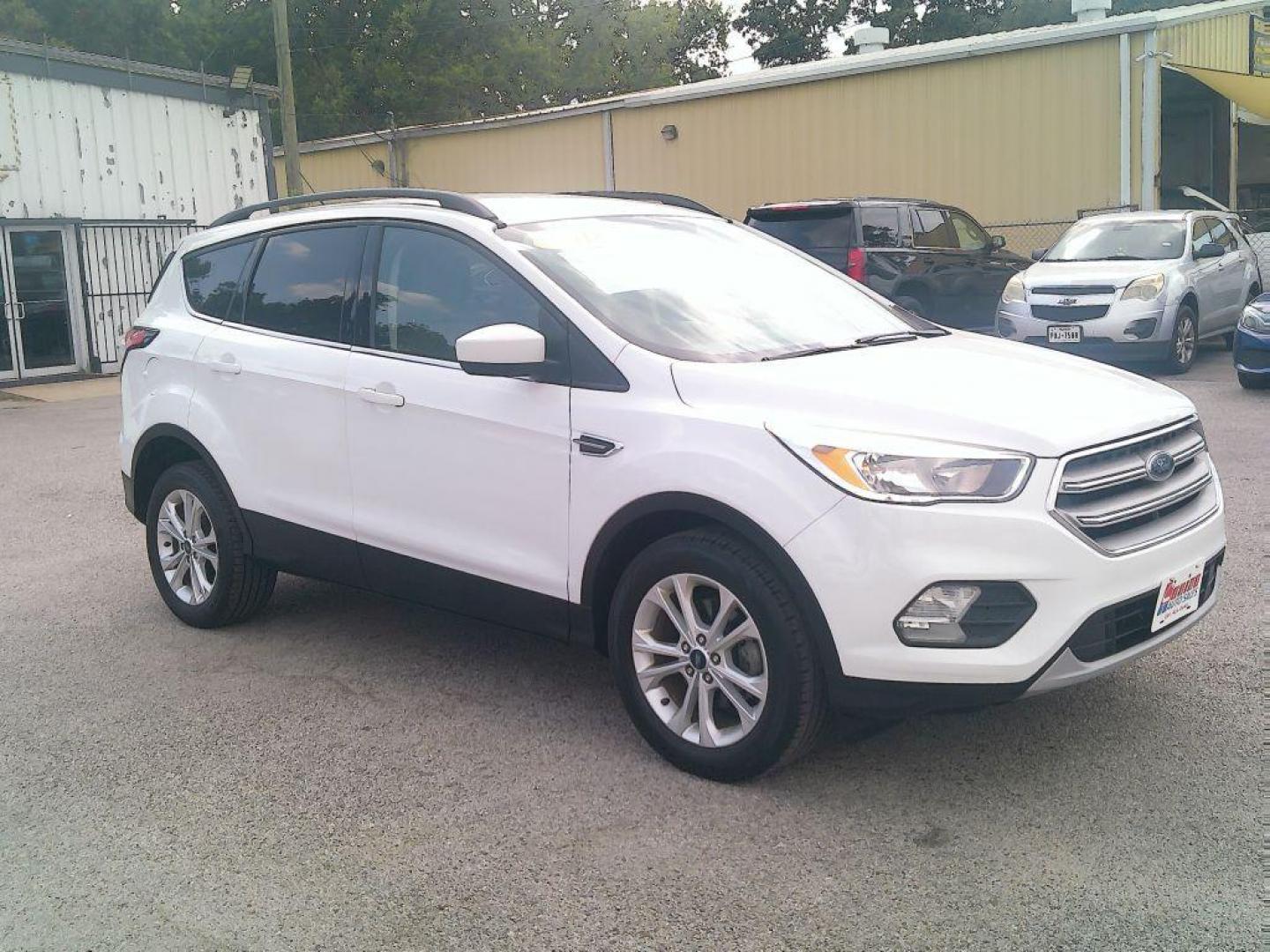 2018 WHITE FORD ESCAPE SE (1FMCU0GD9JU) with an 1.5L engine, Automatic transmission, located at 830 E. Canino Rd., Houston, TX, 77037, (281) 405-0440, 38.358219, -81.729942 - Photo#1