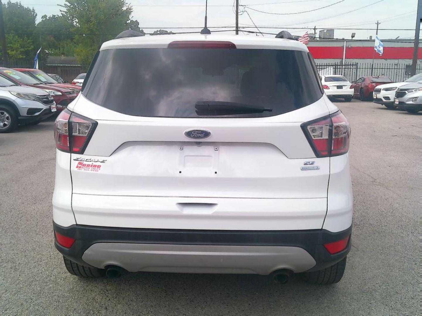 2018 WHITE FORD ESCAPE SE (1FMCU0GD9JU) with an 1.5L engine, Automatic transmission, located at 830 E. Canino Rd., Houston, TX, 77037, (281) 405-0440, 38.358219, -81.729942 - Photo#3