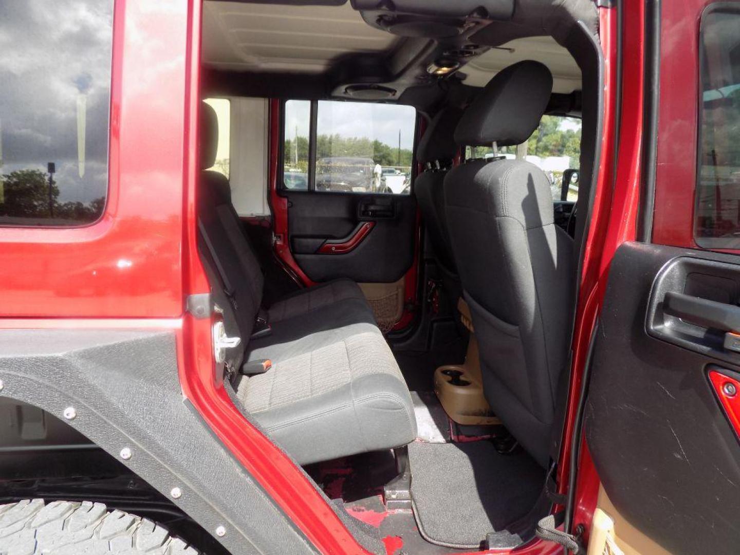 2012 MAROON JEEP WRANGLER UNLIMI SAHARA (1C4HJWEG7CL) with an 3.6L engine, Automatic transmission, located at 830 E. Canino Rd., Houston, TX, 77037, (281) 405-0440, 38.358219, -81.729942 - Photo#11