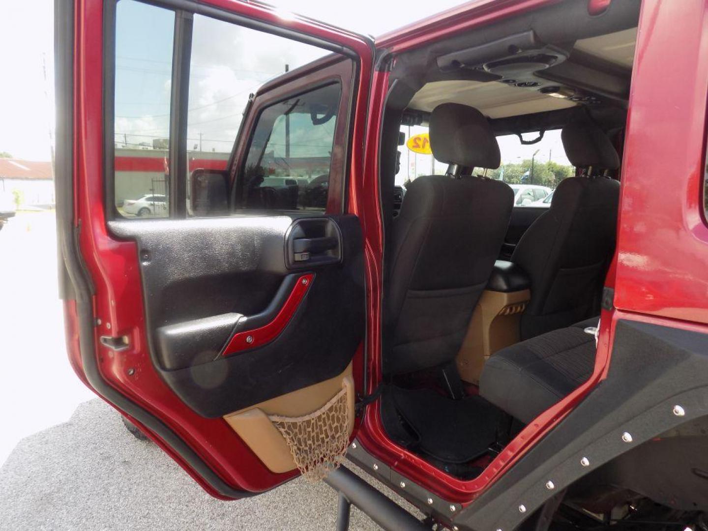 2012 MAROON JEEP WRANGLER UNLIMI SAHARA (1C4HJWEG7CL) with an 3.6L engine, Automatic transmission, located at 830 E. Canino Rd., Houston, TX, 77037, (281) 405-0440, 38.358219, -81.729942 - Photo#12