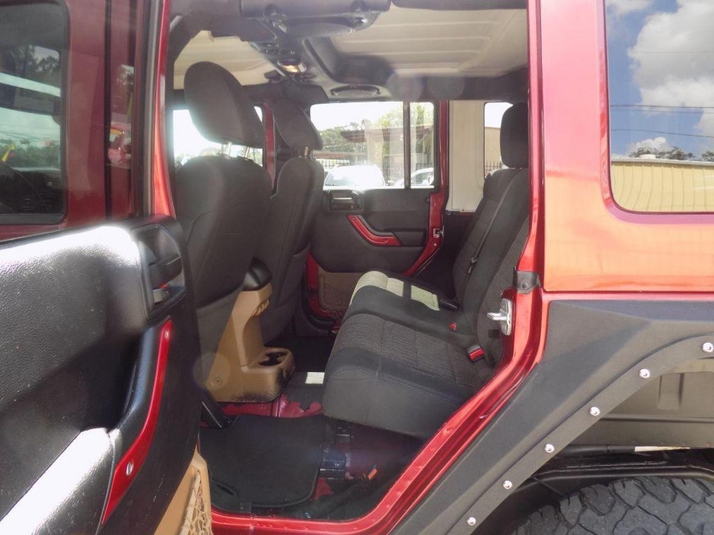 2012 MAROON JEEP WRANGLER UNLIMI SAHARA (1C4HJWEG7CL) with an 3.6L engine, Automatic transmission, located at 830 E. Canino Rd., Houston, TX, 77037, (281) 405-0440, 38.358219, -81.729942 - Photo#13