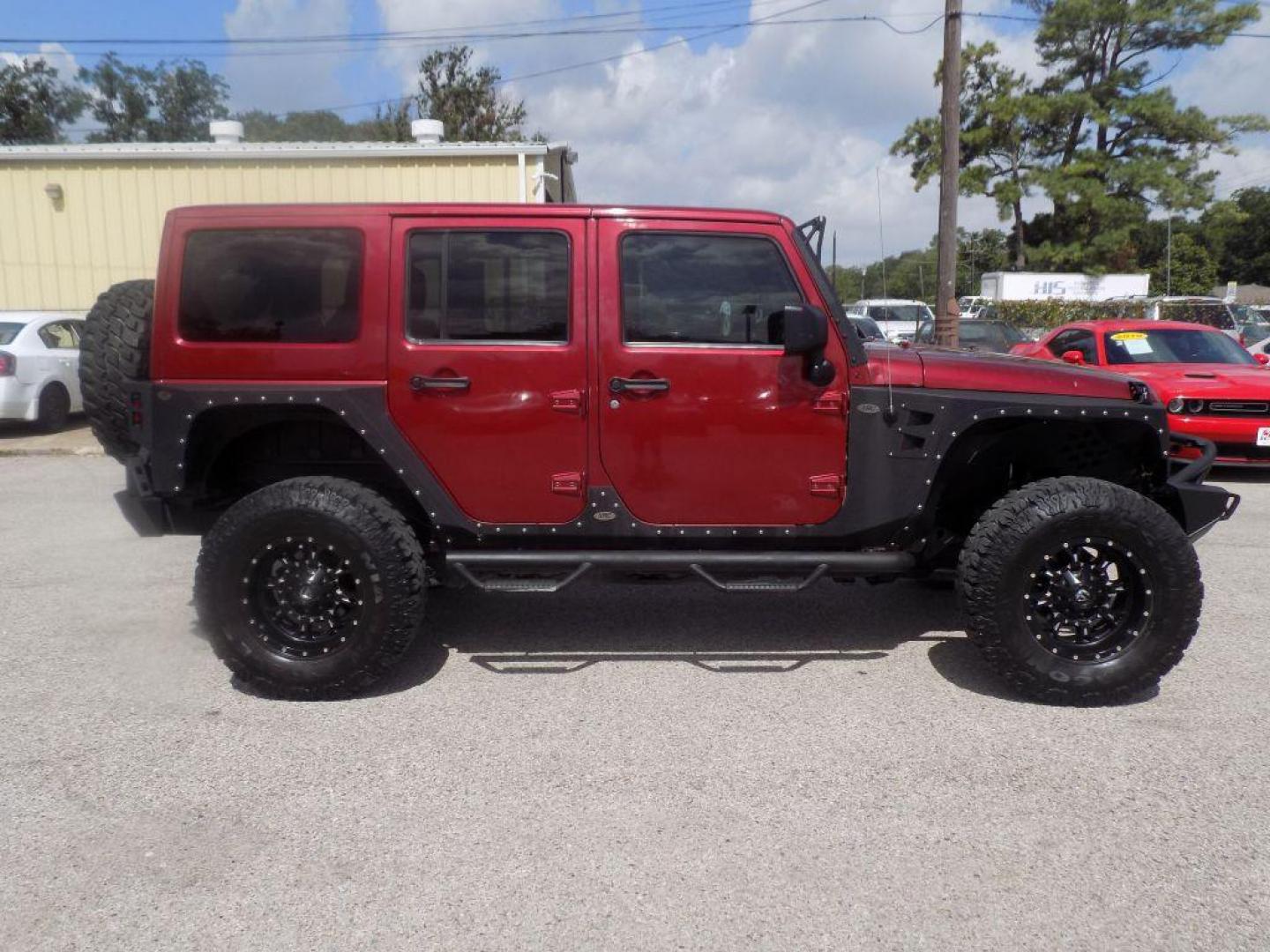 2012 MAROON JEEP WRANGLER UNLIMI SAHARA (1C4HJWEG7CL) with an 3.6L engine, Automatic transmission, located at 830 E. Canino Rd., Houston, TX, 77037, (281) 405-0440, 38.358219, -81.729942 - Photo#1