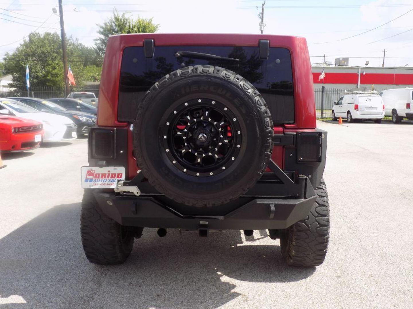 2012 MAROON JEEP WRANGLER UNLIMI SAHARA (1C4HJWEG7CL) with an 3.6L engine, Automatic transmission, located at 830 E. Canino Rd., Houston, TX, 77037, (281) 405-0440, 38.358219, -81.729942 - Photo#2