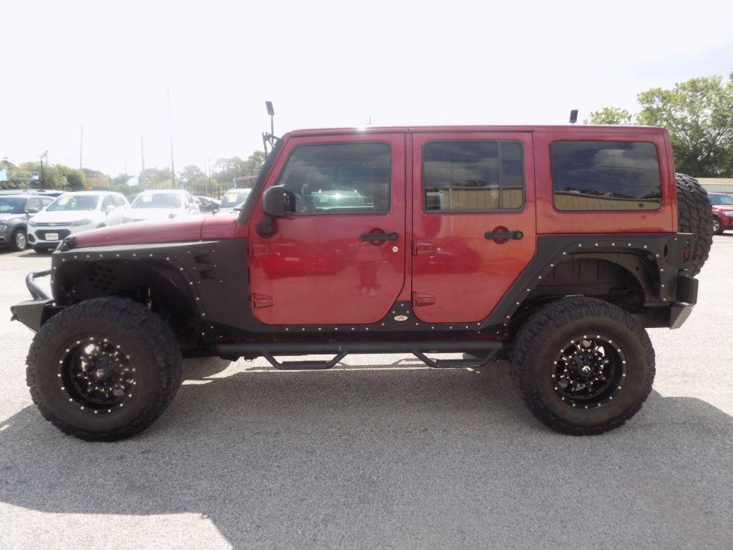 2012 MAROON JEEP WRANGLER UNLIMI SAHARA (1C4HJWEG7CL) with an 3.6L engine, Automatic transmission, located at 830 E. Canino Rd., Houston, TX, 77037, (281) 405-0440, 38.358219, -81.729942 - Photo#3