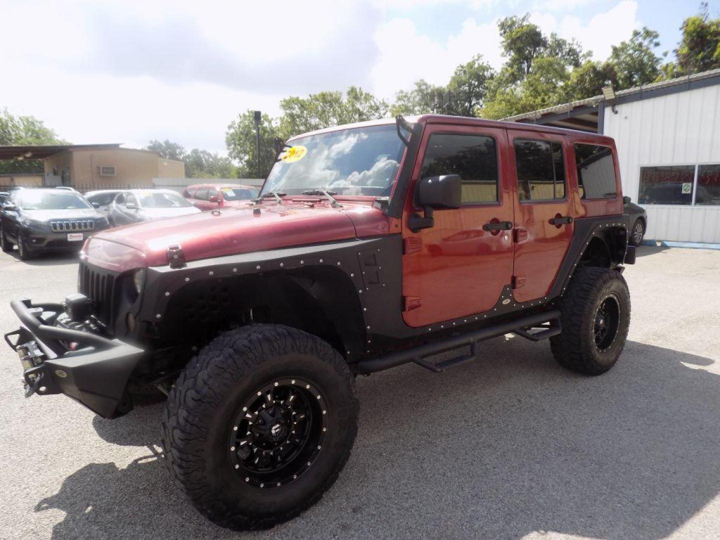 2012 MAROON JEEP WRANGLER UNLIMI SAHARA (1C4HJWEG7CL) with an 3.6L engine, Automatic transmission, located at 830 E. Canino Rd., Houston, TX, 77037, (281) 405-0440, 38.358219, -81.729942 - Photo#5