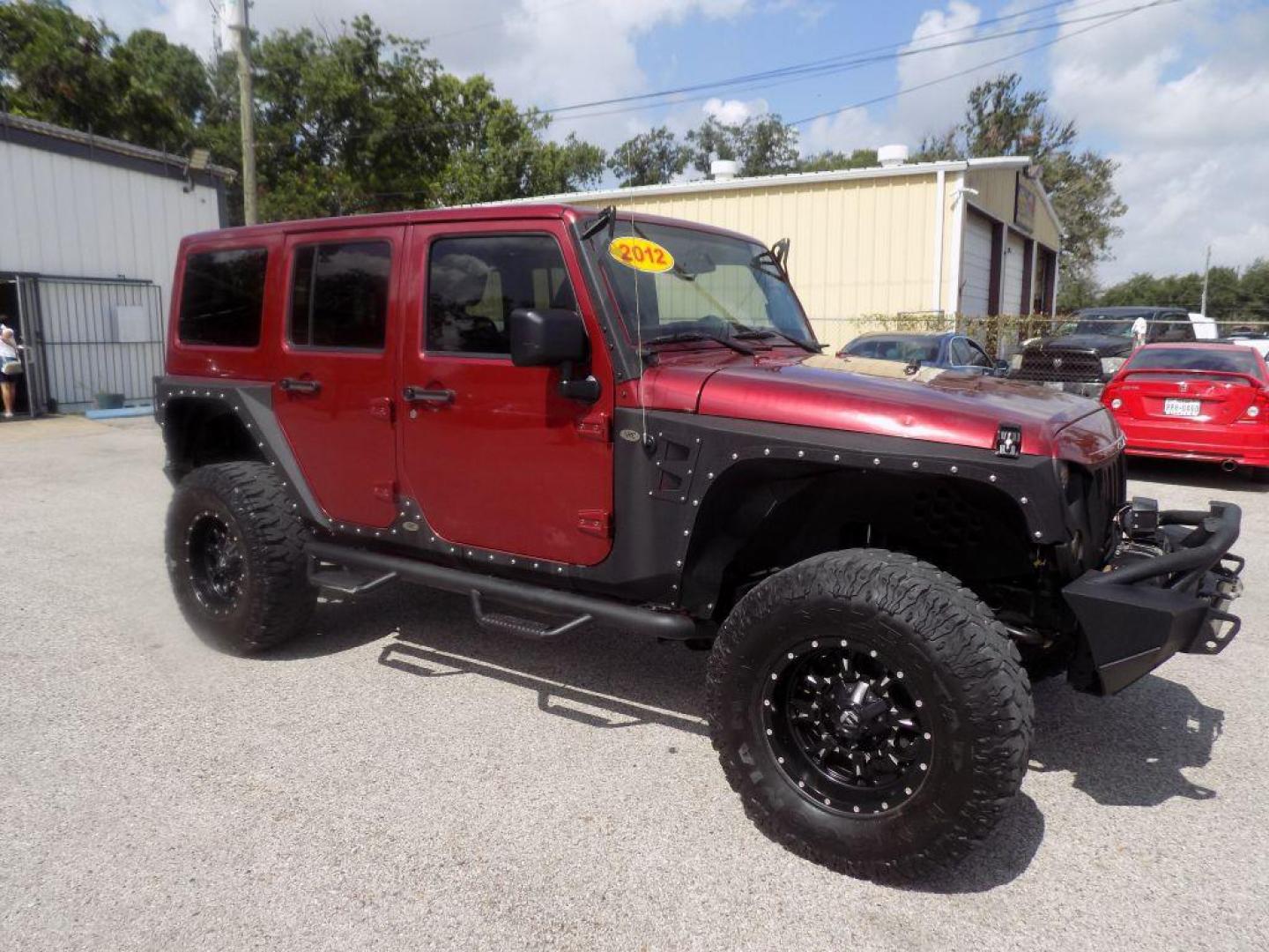 2012 MAROON JEEP WRANGLER UNLIMI SAHARA (1C4HJWEG7CL) with an 3.6L engine, Automatic transmission, located at 830 E. Canino Rd., Houston, TX, 77037, (281) 405-0440, 38.358219, -81.729942 - Photo#6