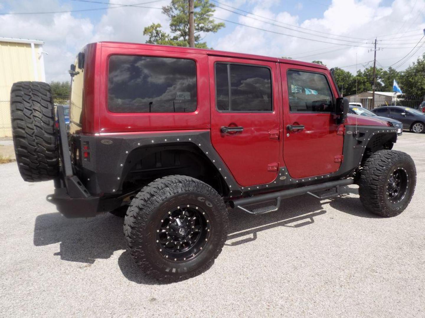 2012 MAROON JEEP WRANGLER UNLIMI SAHARA (1C4HJWEG7CL) with an 3.6L engine, Automatic transmission, located at 830 E. Canino Rd., Houston, TX, 77037, (281) 405-0440, 38.358219, -81.729942 - Photo#7