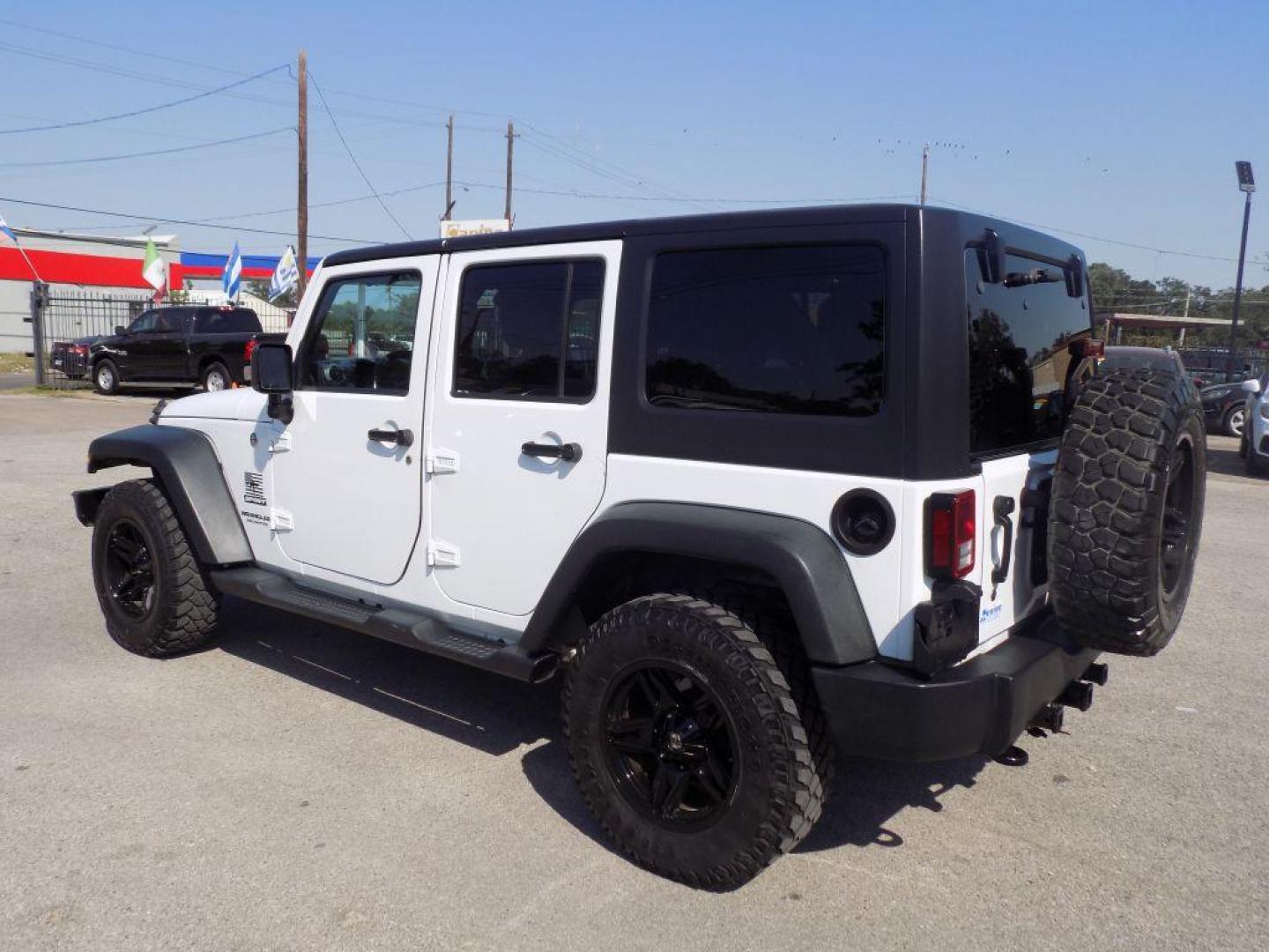 2014 WHITE JEEP WRANGLER UNLIMI SPORT (1C4BJWDG5EL) with an 3.6L engine, Automatic transmission, located at 830 E. Canino Rd., Houston, TX, 77037, (281) 405-0440, 38.358219, -81.729942 - Photo#4