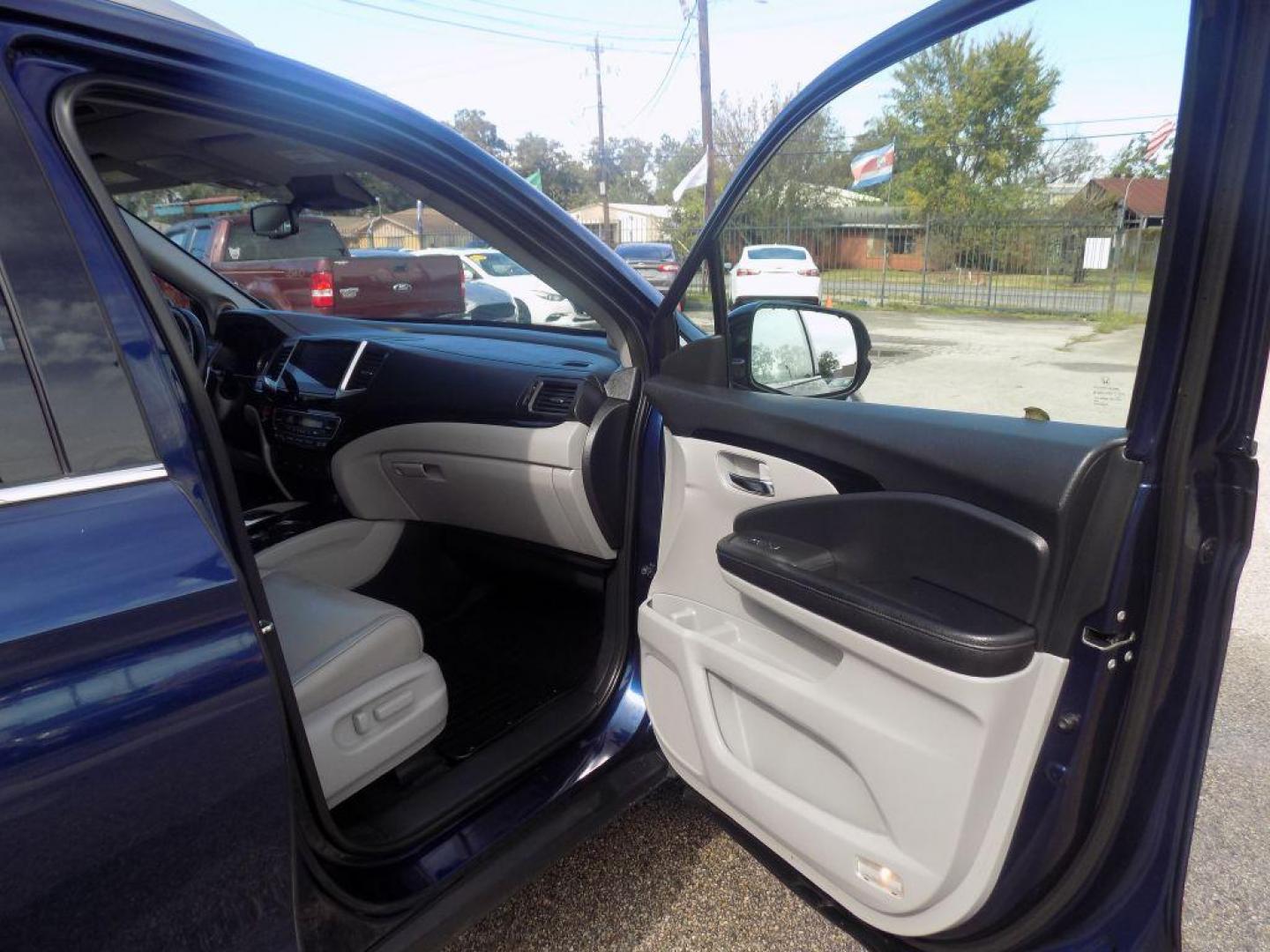 2017 BLUE HONDA PILOT TOURING (5FNYF5H98HB) with an 3.5L engine, Automatic transmission, located at 830 E. Canino Rd., Houston, TX, 77037, (281) 405-0440, 38.358219, -81.729942 - Photo#16