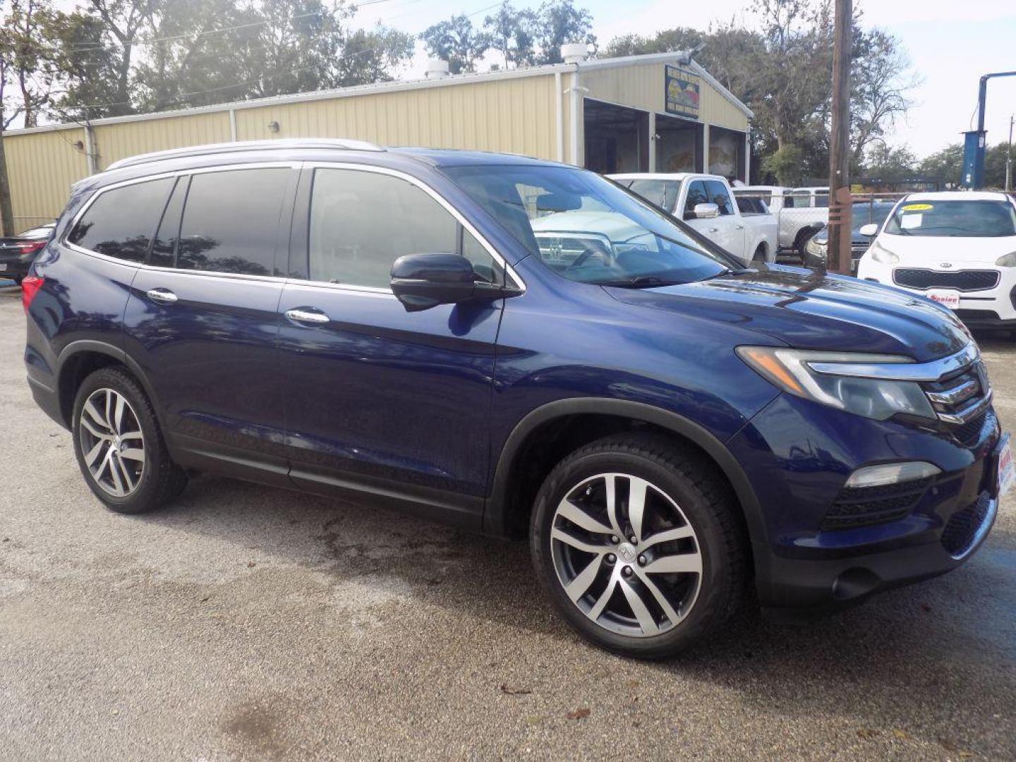 2017 BLUE HONDA PILOT TOURING (5FNYF5H98HB) with an 3.5L engine, Automatic transmission, located at 830 E. Canino Rd., Houston, TX, 77037, (281) 405-0440, 38.358219, -81.729942 - Photo#2